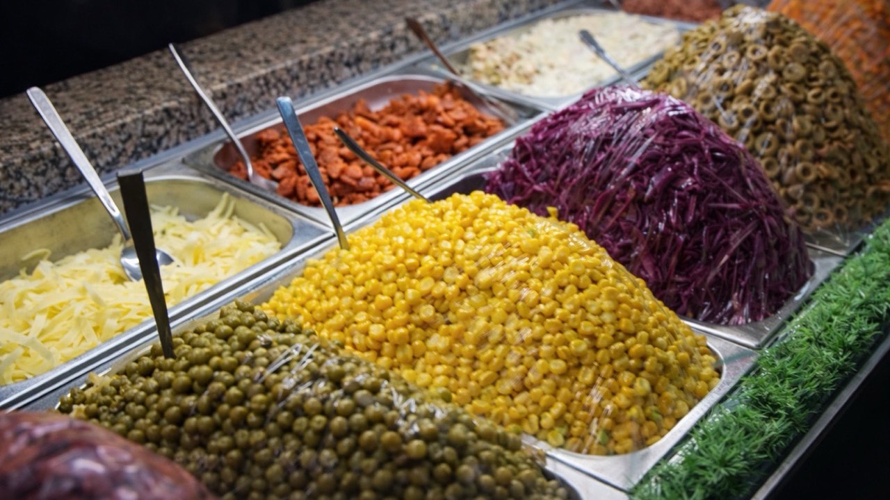 Kumpir topping bar with corn, olives and sauces