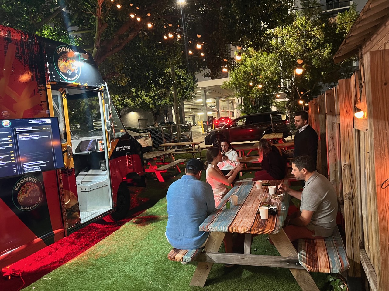 Koompir food truck garden seating at night with string lights