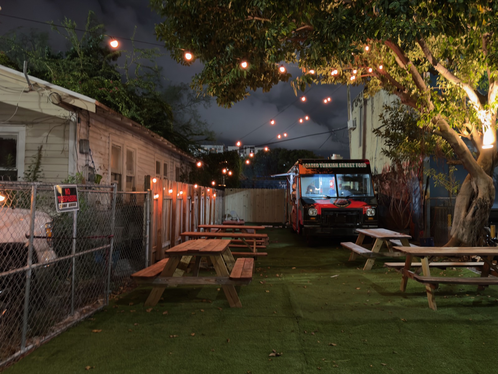 Koompir food truck night garden with string lights Miami